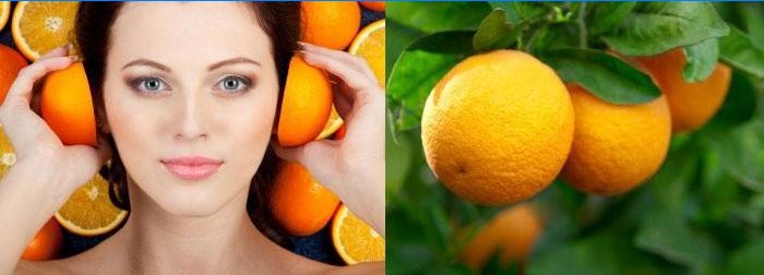 Femeia ține portocale